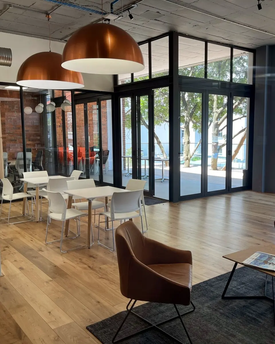 Lounge and dining space at 14 Kloof Street with copper pendant lights and glazed doors to a terrace